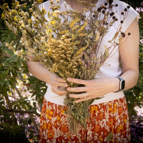me holding a bouquet of wildflowers